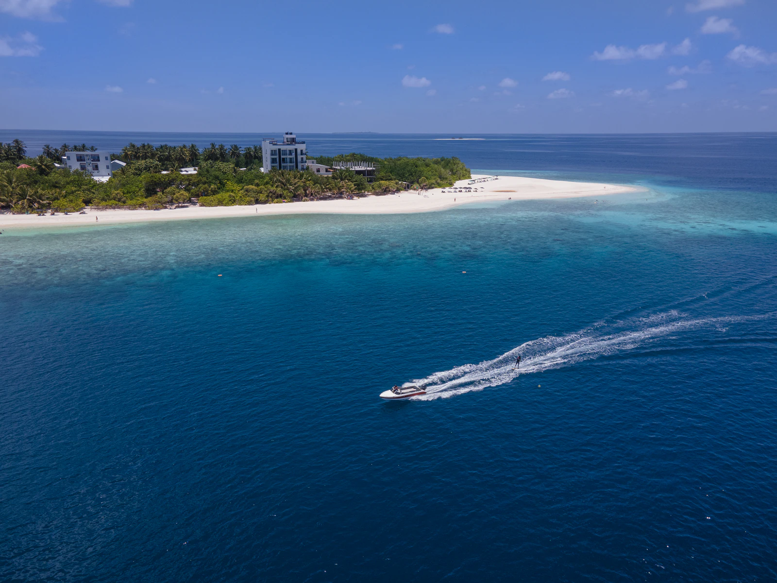 Aerial view of the Ukulhas coastline with a speedboat offshore