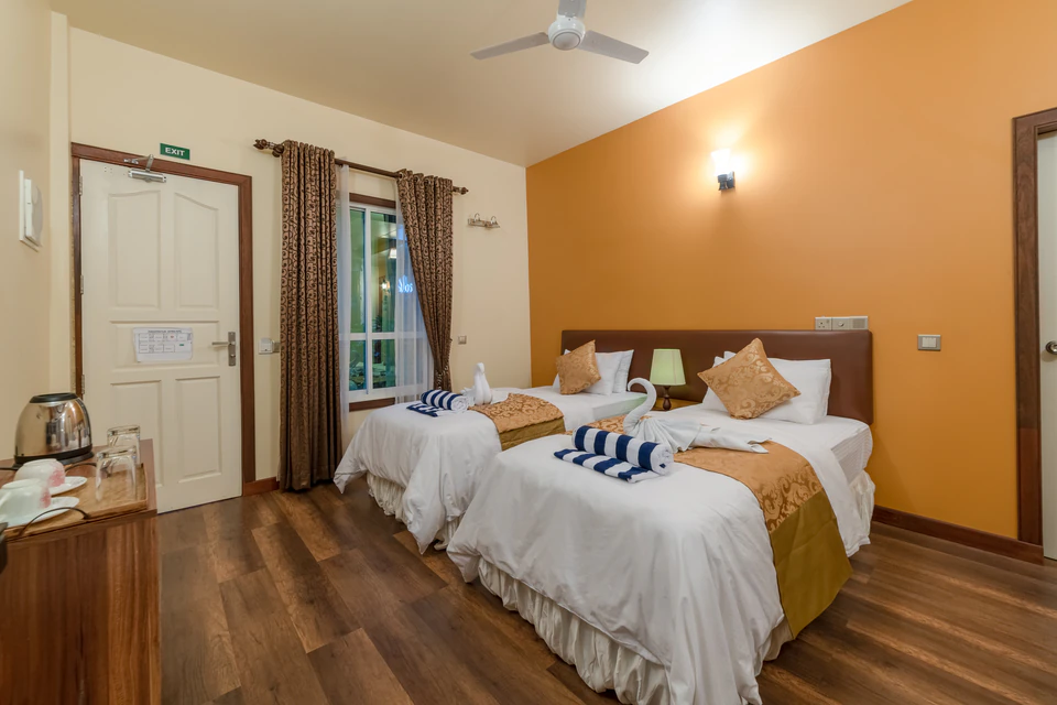 Twin-bed room view with window and entrance