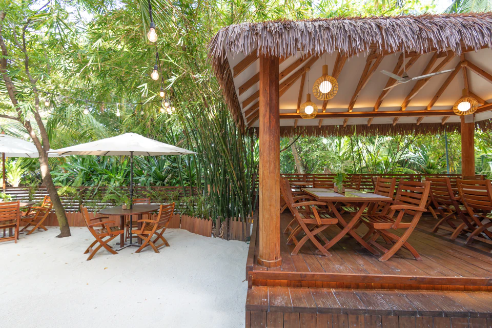 Thatched restaurant gazebo and open-air courtyard dining tables