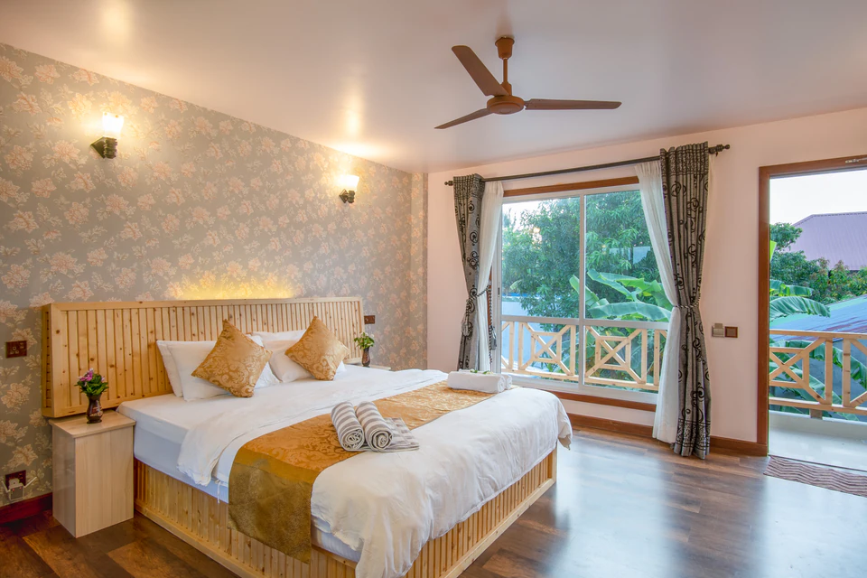 Double bed and two balcony doorways