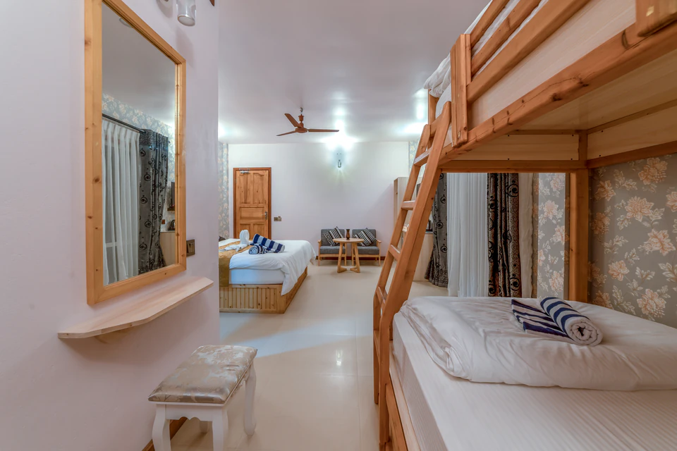 View past the bunk beds toward the double bed