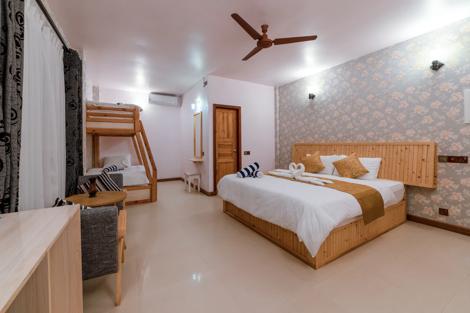 Wide family room view with a double bed and bunk beds