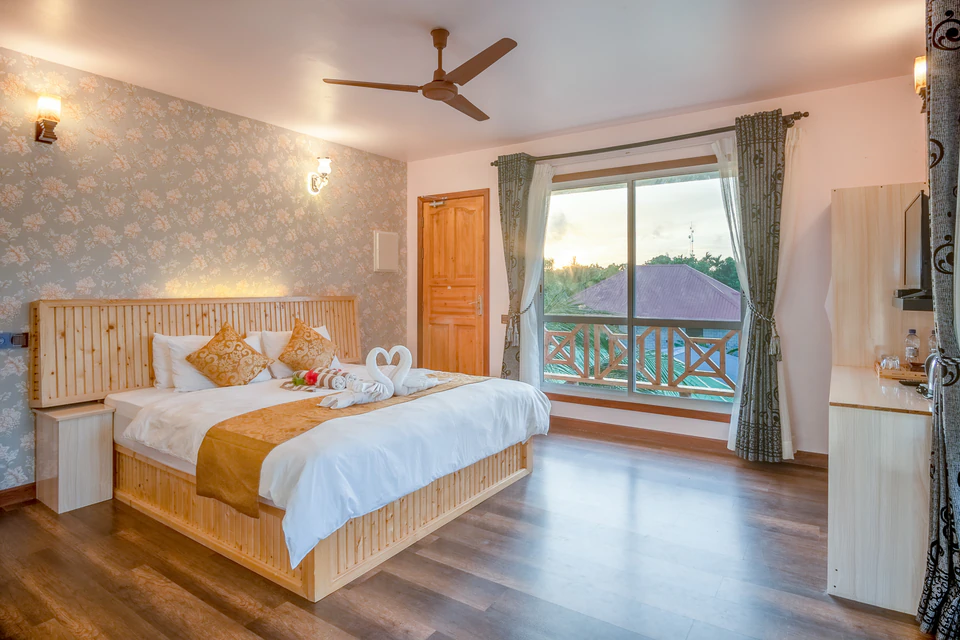 Wide view of the double bed and balcony doorway