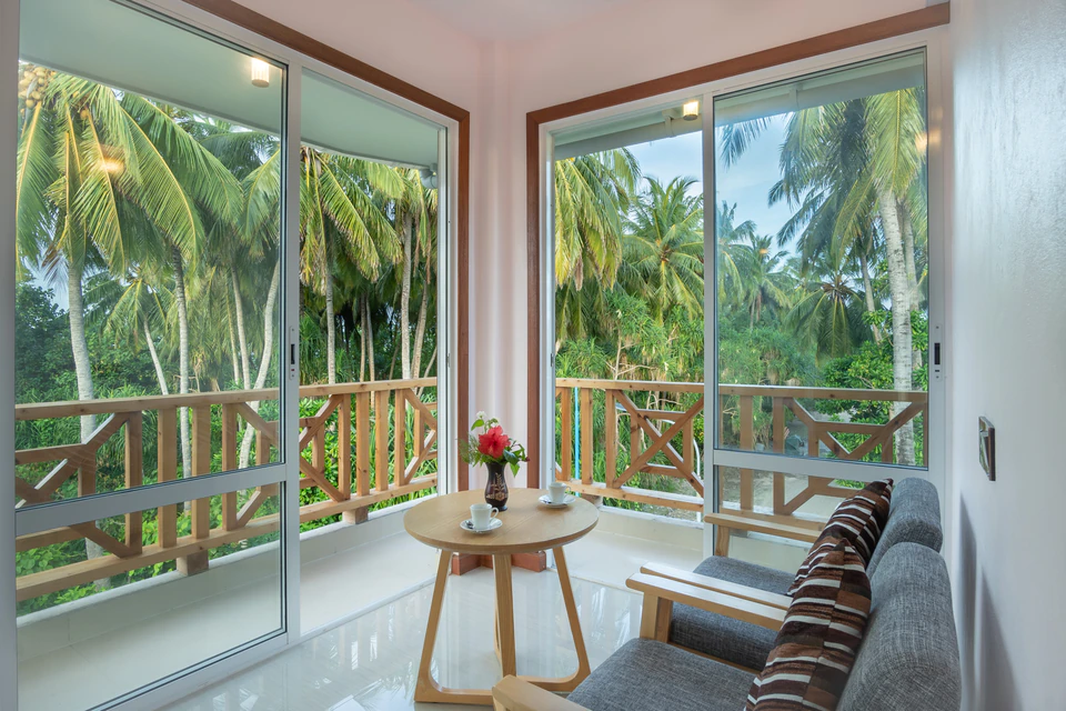 Indoor seating area beside large windows and the balcony