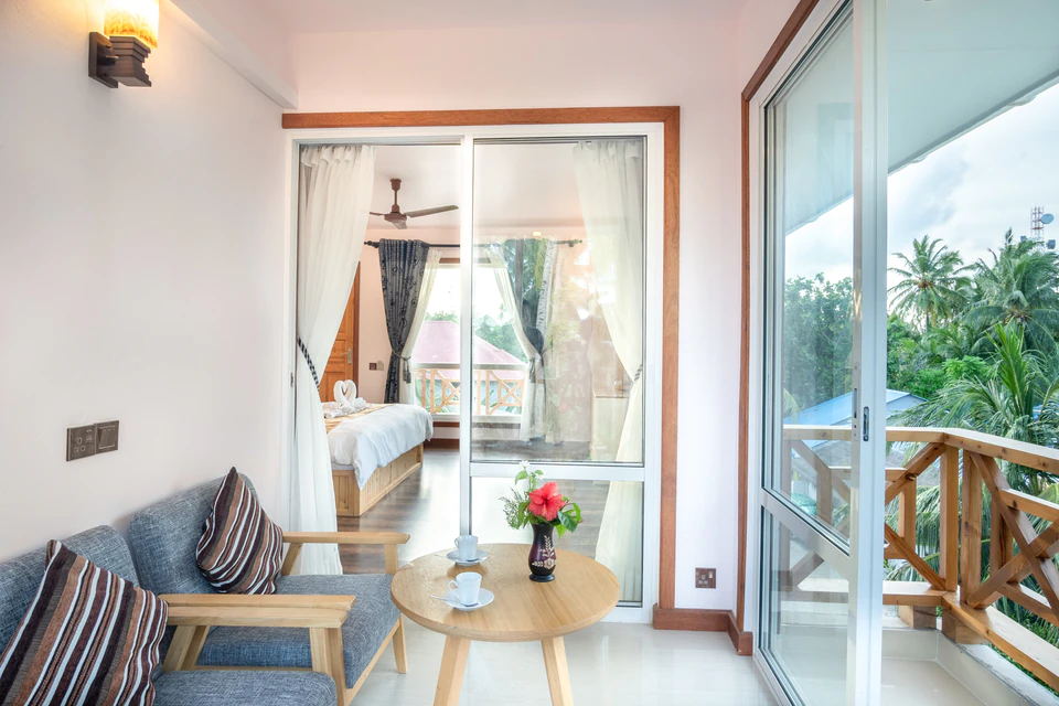 Seating area and balcony windows viewed from the bedroom