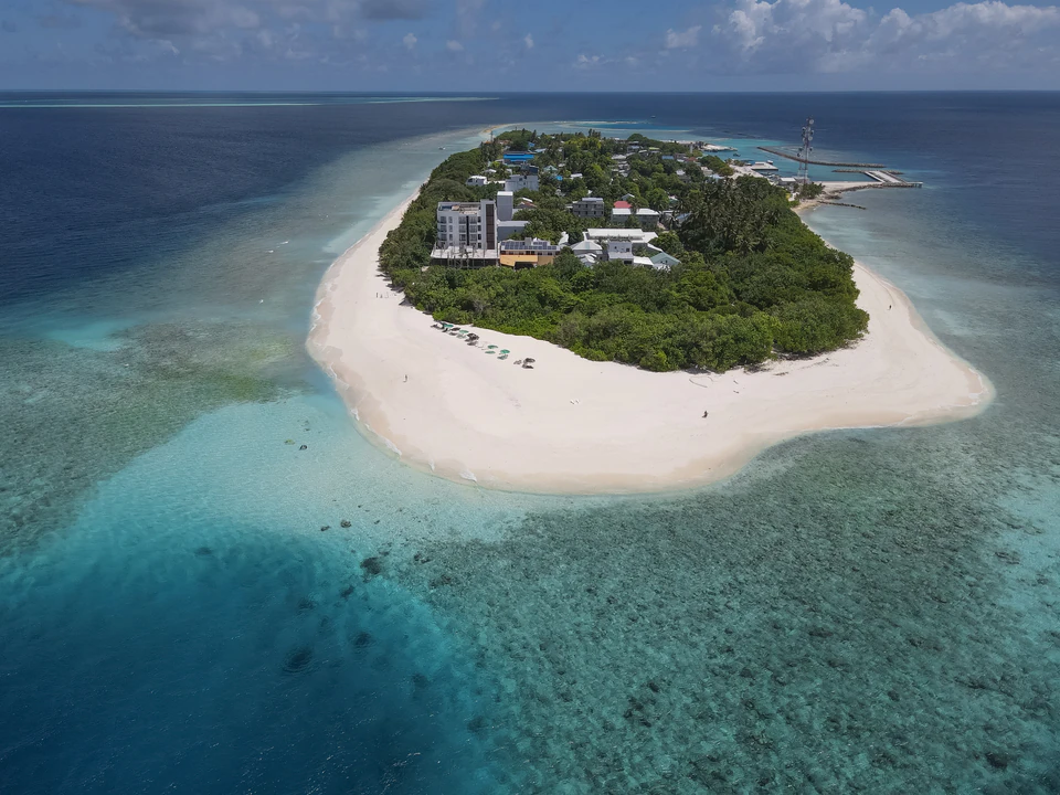 Aerial view of Ukulhas island, beach, lagoon, and surrounding reef