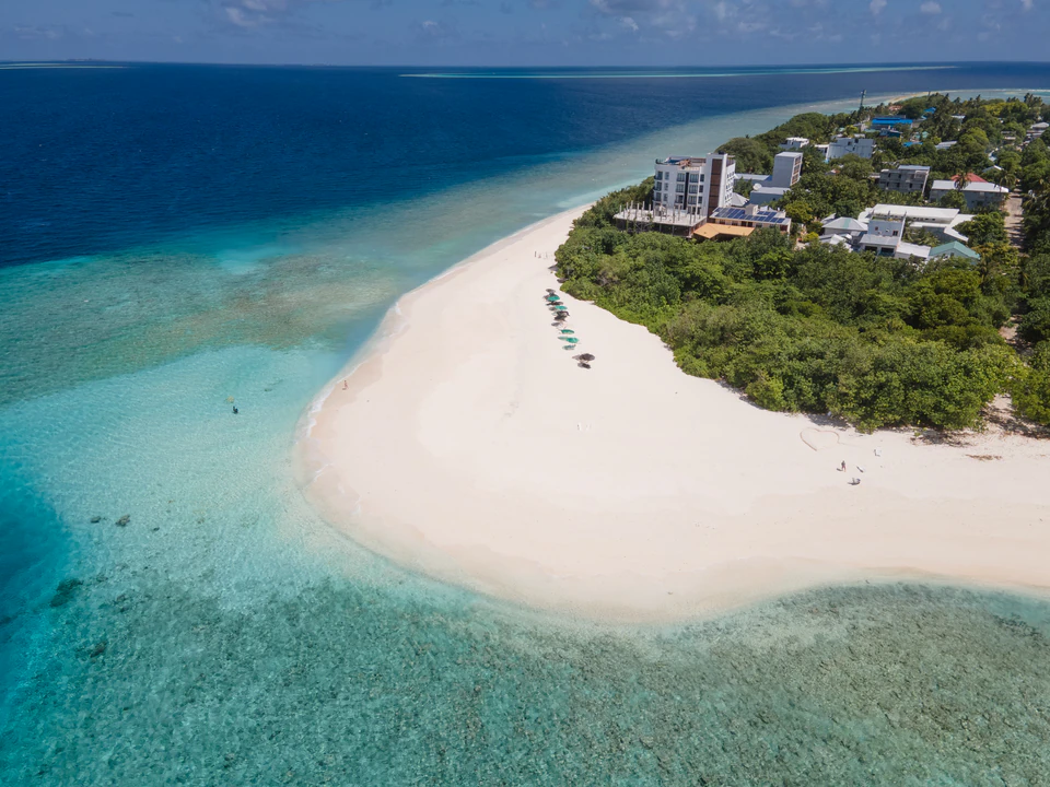 Closer aerial view of the Ukulhas shoreline, white beach, and reef